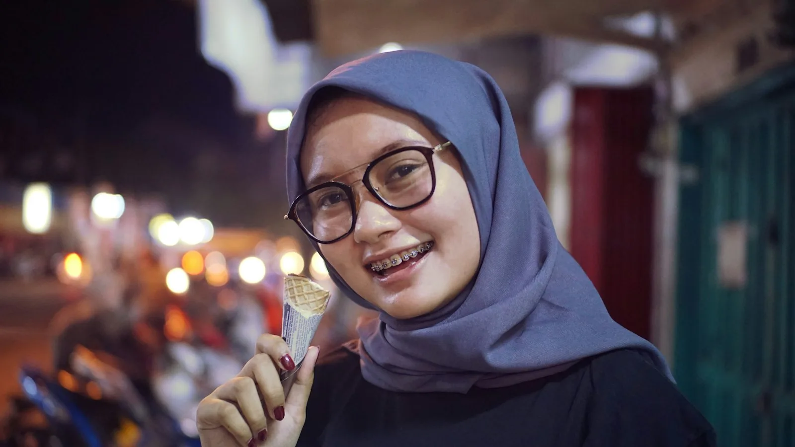 A woman smiling at a night market